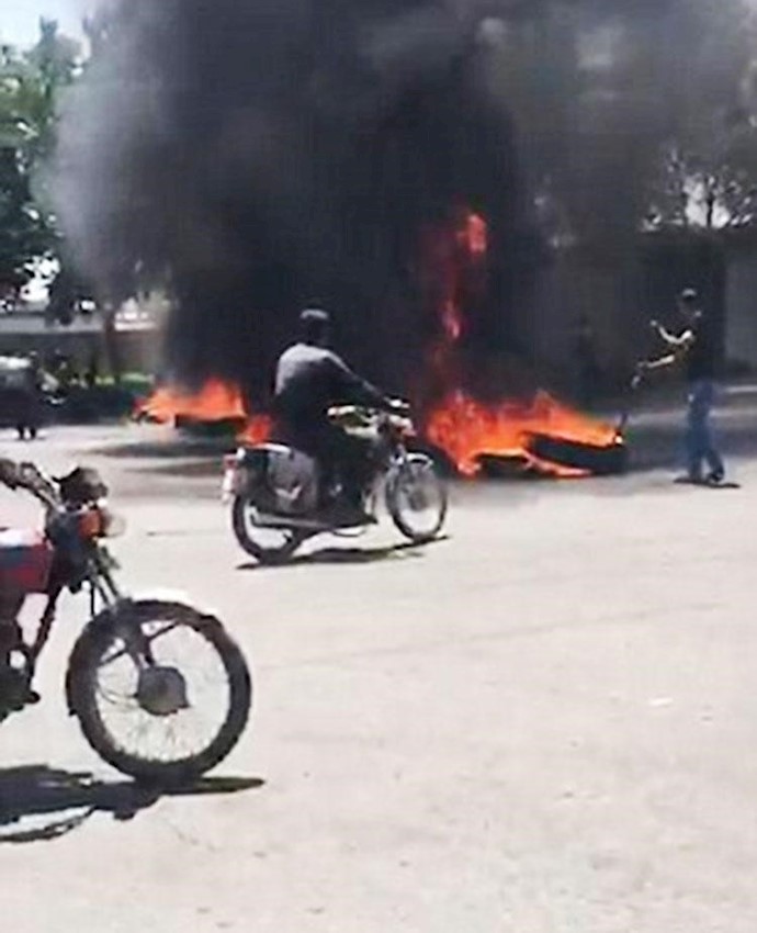 Protesters seen setting tires on fire to protect themselves against security forces