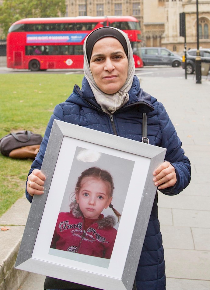 Dr Hala Al Ghawi holds a photograph of one of her colleagues children who was detained