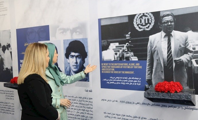 NCRI President-elect Maryam Rajavi and Mrs. Monika Kryemadhi, leader of the Albanian Socialist Movement, standing before the portrait of Kazem Rajavi in Ashraf 3 