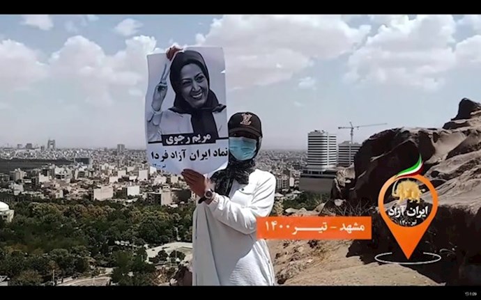 Mashhad July 10, 2021 – A woman holds an image of the Iranian Opposition leader Maryam Rajavi